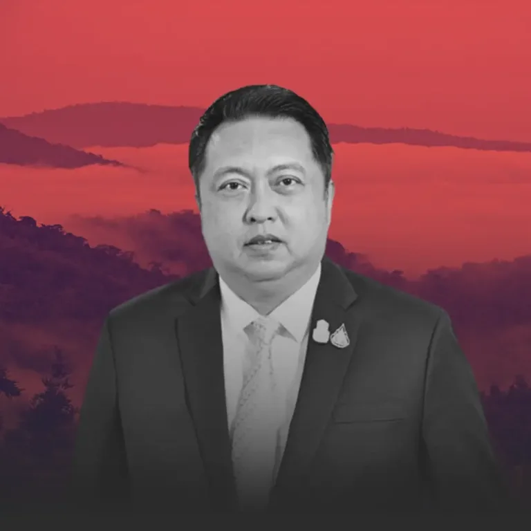 Portrait of a man in a suit and tie against a red sunset backdrop with hills in the distance (grayscale foreground).