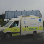 French emergency ambulance SAMU 93 with Médecin markings parked outside a glass-front building.
